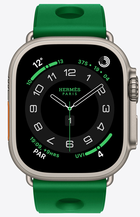 Apple Watch Hermès Ultra 4, Circulaire analogue watch face, (hour, minute and second hands, complications: Weather, Activity rings, Paris time and UV index), titanium case, natural colour, right side exterior, Digital Crown, raised side button, paired with Scub'H Diving strap, Vert Vertigo colour (bright green), moulded rubber material, circular cutouts centred