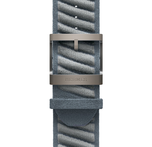 Apple Watch Hermès Ultra 3 En Mer band, bleu gris/bleu glacier color (blue gray with light gray diagonal textured stripes), knit polyamide yarn material, adjustment holes centered, natural color titanium buckle engraved with Hermès